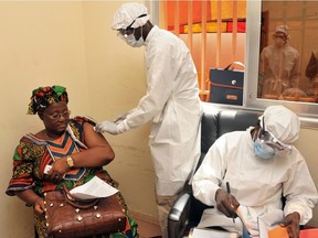 A woman receives the Canadian-developed VSV-EBOV in Conakry, Guineau in March 2015.