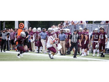 Harrison Tallyhoe of the Marauders tries to get away from the Gee-Gees' Jamie Harry.