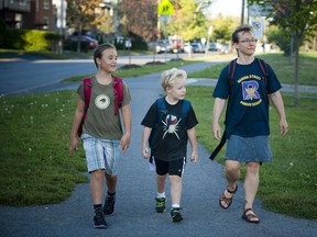Heather Amundrud and her two kids, nine year old Anna Weatherup and seven Adam Weatherup walking to their first day back to school at Regina Street Public School Tuesday September 6, 2016.   Photos by Ashley Fraser