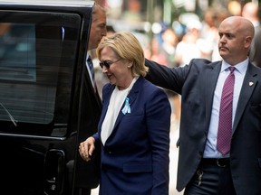Democratic presidential candidate Hillary Clinton gets into a van as she leaves an apartment building Sunday, Sept. 11, 2016, in New York. Clinton's campaign said the Democratic presidential nominee left the 9/11 anniversary ceremony in New York early after feeling "overheated."