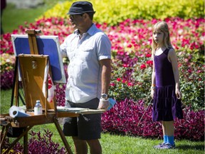 Jacques Boissinot works on a painting in the gardens at Kingsmere while eight-year-old Rory Lee keeps a close eye on his artwork in Gatineau Park on Saturday, Sept. 3, 2016.