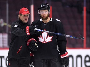 Team Canada's Jake Muzzin talks with head coach Mike Babcock during practice in Ottawa on Wednesday, Sept. 7, 2016. The two-week World Cup tournament, featuring more than 150 of the best players in the NHL, starts Saturday Sept. 17, 2016.