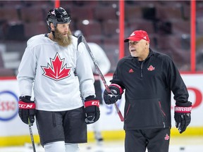 Joe Thornton talks with coach Barry Trotz as Team Canada practices at Canadian Tire Centre in preparation for the World Cup of Hockey Tournament.