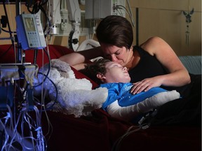 Jonathan Pitre is comforted by his mother, Tina Boileau, following a draining round of radiation Wednesday (Sept. 7, 2016) at the University of Minnesota Masonic Children's Hospita on the even of becoming the first Canadian to undergo an EB bone marrow transplant.