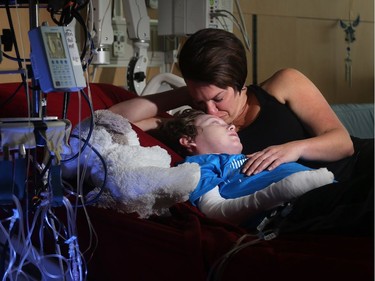 Jonathan Pitre is comforted by his mother, Tina Boileau, following a draining round of radiation Wednesday (Sept. 7, 2016) at the University of Minnesota Masonic Children's Hospita on the even of becoming the first Canadian to undergo an EB bone marrow transplant.