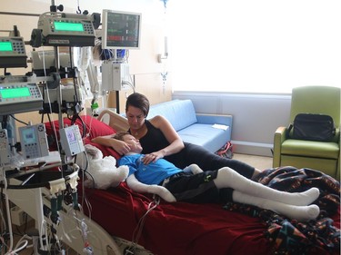 Jonathan Pitre is comforted by his mother, Tina Boileau, following a draining round of radiation Wednesday (Sept. 7, 2016) at the University of Minnesota Masonic Children's Hospita on the even of becoming the first Canadian to undergo an EB bone marrow transplant.