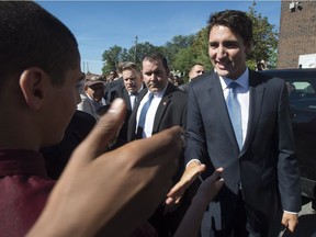 Canadian Prime Minister Justin Trudeau shakes hands with members of the Muslim community as he leaves a mosque in Ottawa, Monday September 12, 2016.