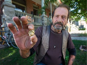 Larry Mantha displays the golden nugget he found. A pawn shop has offered him $309 for it but he's not sure he wants to sell.