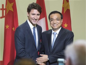 Chinese Premier Li Keqiang, and Canadian Prime Minister Justin Trudeau shake hands after speaking to a business luncheon Friday, September 23, 2016 in Montreal.THE CANADIAN PRESS/Ryan Remiorz ORG XMIT: RYR101