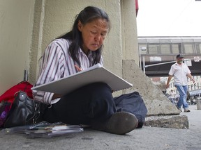 Annie Pootoogook in 2012, drawing on the sidewalk near the Rideau Centre.