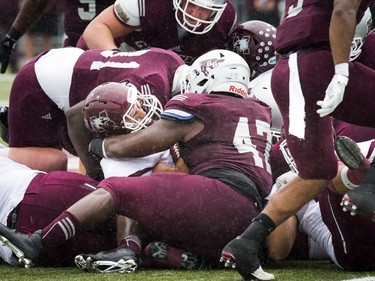 The Marauders' Asher Hastings holds onto the ball after being tackled.