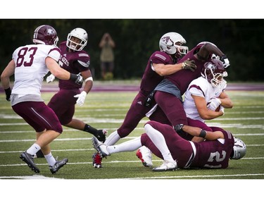 The Marauders' Danny Vandervoort protects the ball while the Gee-Gees try to stop him.