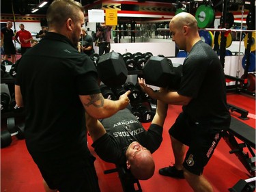 Mark Borowiecki of the Ottawa Senators lifts two 110lbs weights during the first day of training camp.