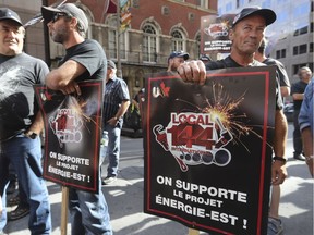 Some like the pipeline: Pipe fitters stand outside the conference centre where the National Energy Board was to hold public hearings in Montreal this week. Anti-pipeline activists forced the shutdown of the meeting, however.