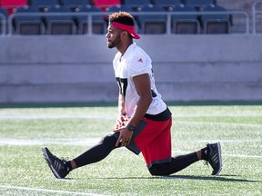 Mossis Madu stretches as the Ottawa Redblacks hold a walkthrough practice in advance of their ned game on Friday night against the Toronto Argonauts at TD Place.