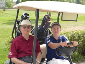 Lonnie Sarazin of Ottawa rides with great-grandson Andrew Sarazin at the Landings Golf Course in Kingston. (Photo by Jack Verheyden)