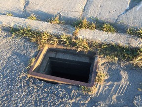 An uncovered manhole on Queensbury Drive.