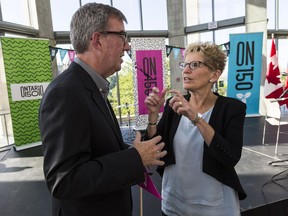 Ontario Premier Kathleen Wynne speaks with Ottawa Mayor Jim Watson following the announcement of Ontario150, a year-long celebration celebrating the 150th anniversary of Confederation.