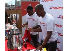 Ottawa Fury FC defender Eddie Edward (left) and Ottawa REDBLACKS quarterback Henry Burris signed jerseys to be given away as part of the promotion to bring in cash and non-perishable food items for the Ottawa Food Bank