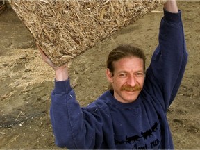 Ottawa - Louis Rompre, in March 2000, holds up one of his 'bioblocks' which was used to construct beekeeper Tijs Bellaar-Spruyt's Honey House located in the background. Photo by WAYNE CUDDINGTON, THE OTTAWA CITIZEN