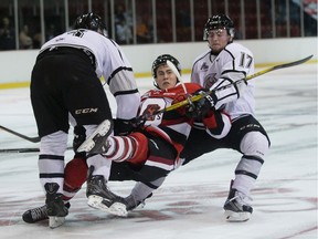 The Ottawa 67's Carter Robertson is taken down by the Gatineau Olympiques' Olivier Crevier, left, and Charles-Olivier Ouimet  during exhibition action at the Robert Guertin Centre on Friday, Sept. 9, 2016.