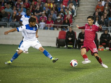 Ottawa Fury FC Mauro Eustaquio battles for the ball against Dustin Corea of FC Edmonton.