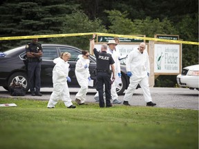 Crime lab technicians arrive after the body of a man was discovered at the Experimental Farm Saturday.