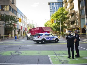 Ottawa Police investigate a fatal cyclist crash at the corner of Laurier Avenue and Lyon Street Thursday.