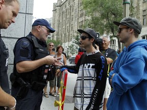 Ottawa Police speak to two young men who left a car padlocked near the U.S. embassy Saturday.