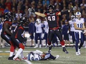 Ottawa Redblacks defensive lineman Ettore Lattanzio (49) celebrates after tackling Toronto Argonauts running back Brandon Whitaker (3) in CFL action at TD Place on Friday, Sept. 23, 2016.