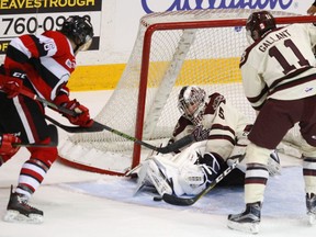 Peterborough Petes' goalie Scott Smith covers up a rebound in front of  Ottawa 67's Ben Evans as Zach Gallant moves in during first period OHL action of the Petes home opener on Thursday September 22, 2016 at the Memorial Centre in Peterborough, Ont. Clifford Skarstedt/Peterborough Examiner/Postmedia Network