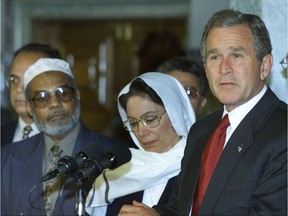 Former U.S. President George W. Bush speaks as he stands with Muslim religious leaders during a visit to the Islamic Center of Washington September 17, 2001 in hopes of putting an end to rising anti-Muslim sentiment in the wake of the terrorist attacks on the World Trade Center and Pentagon.