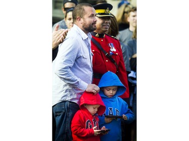 RCMP Const. Sarah Beckett's husband, Brad Aschenbrenner, and sons, Emmit, left, and Lucas, were honoured at a Parliament Hill ceremony on Saturday, Sept. 24, 2016. Beckett was killed in a crash in Langford, B.C., on April 5, 2016. She was 32.