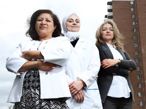 Sawsan Abdul-Majid with program participants Farzan Asbhi, who has a master's degree in pharmacy and Fedaa Khirallah, an agricultural engineer.