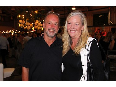 Scott Warrick, culinary programs coordinator and professor with Algonquin College's School of Hospitality and Tourism, with Cathy Dewar, manager of the college's Restaurant International, at the 25th anniversary party for Thyme & Again Creative Catering and Take Home Food Shop, held at the Horticulture Building on Friday, September 9, 2016. (Caroline Phillips / Ottawa Citizen)
