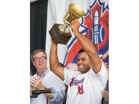 Sebastien Boucher hoists the cup with mayor Jim Watson looking on as the Ottawa Champions are given a heroes welcome at Ottawa City Hall following their victory in the Can-Am League Championship over the weekend.