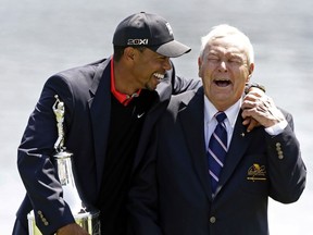 Tiger Woods, left, jokes with Arnold Palmer after winning the Arnold Palmer Invitational golf tournament, Monday, March 25, 2013, in Orlando, Fla.
