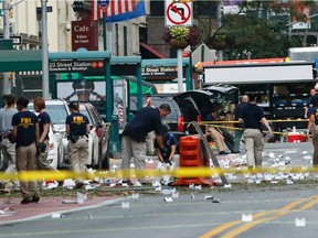 TOPSHOT - Law Enforcement Officers are seen at the scene of an explosion on West 23rd Street September, 18, 2016 in New York. An explosion rocked one of the most fashionable neighborhoods of New York on September 17 night, injuring 29 people, one seriously, a week after America's financial capital marked the 15th anniversary of the 9/11 attacks. Mayor Bill de Blasio indicated the blast was not accidental, even if there was no known link to terrorism. The blast occurred in Chelsea -- an area packed with bars, restaurants and luxury apartment blocks -- at a typically bustling time of the weekend.
