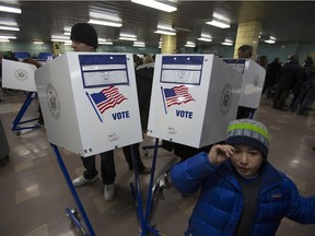 Voters cast their ballots at a polling location in the Manhattan borough of New York, U.S., on Tuesday, Nov. 6, 2012.