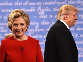 Democratic nominee Hillary Clinton (L) and Republican nominee Donald Trump leave the stage after the first presidential debate at Hofstra University in Hempstead, New York on September 26, 2016. /