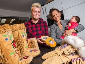 Waneek Horn-Miller, (R), holding her 8 week old baby girl, and Tara Barnes of Manitoba Mukluks are launching an indigenous school to teach mukluk making.