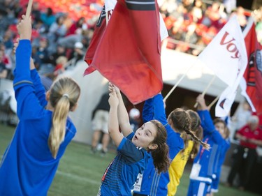 Youngsters held the flags as the teams made their entrance onto the field.
