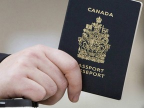 A passenger holds his Canadian passport