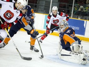 67's Travis Barron tries to get the puck from the Flint Firebirds at TD Place arena Sunday October 30, 2016.  Ashley Fraser/Postmedia    67's