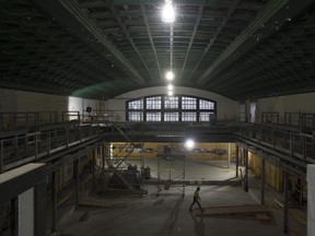 A construction worker walks across the floor where the temporary Senate chamber will be located at the Government Conference Centre across from the Château Laurier.