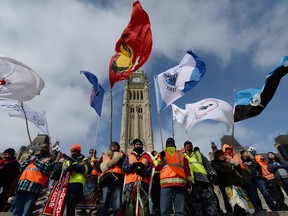 A group of First Nations adults and youth on Parliament Hill in 2014.