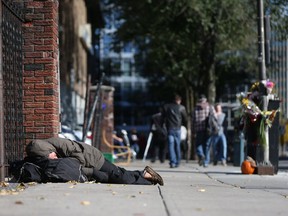 A man sleeps near the Salvation Army on George Street in Ottawa  Wednesday Oct. 19, 2016.