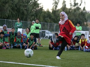 A Syrian girl from the Zaatari refugee camp kicks the ball during a friendly game of football with the Japanese U17 Women's World Cup team and five Jordanian girls, in Amman, Jordan, Wednesday, Oct 5, 2016. With support from UNICEF the meet up is part of a program that brings together thousands of Jordanian and Syrian children in host communities through football and art activities.