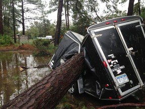 A trailer is destroyed from a fallen tree  in the aftermath of Hurricane Matthew at Hilton Head, S.C., on Saturday, Oct. 8, 2016.  Matthew plowed north along the Atlantic coast, flooding towns and gouging out roads in its path.