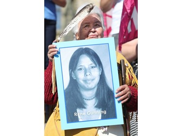 An elderly native woman, Dorothy Meness, holds up a picture of a missing girl. Prime Minister Justin Trudeau, along with a number of his female cabinet ministers, made a surprise visit to a vigil for missing and murdered Indigenous women, girls and Two-Spirit people (MMIWG2S) Tuesday (Oct. 4, 2016) on Parliament Hill.